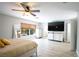 Spacious bedroom with a ceiling fan, wood-look floors, and a view of the bathroom at 10902 Pentland Downs St, Las Vegas, NV 89141