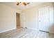 This room features wood-look flooring, a ceiling fan, a large window and closet access at 10902 Pentland Downs St, Las Vegas, NV 89141