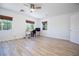 Bright, spacious bedroom with wood-look floors, ceiling fan, and natural lighting at 10902 Pentland Downs St, Las Vegas, NV 89141