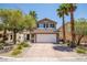 Charming two-story home featuring a brick driveway, desert landscaping, and a two-car garage at 10902 Pentland Downs St, Las Vegas, NV 89141