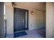 Close-up of a dark-colored front door with a glass insert and brick-paved porch at 10902 Pentland Downs St, Las Vegas, NV 89141