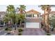 Exterior view of a two-story home with desert landscaping and a two-car garage at 10902 Pentland Downs St, Las Vegas, NV 89141