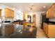 Kitchen with black granite countertops, wood cabinets, and stainless steel appliances at 10902 Pentland Downs St, Las Vegas, NV 89141
