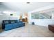 Spacious living area with tile floors, comfortable seating, and an open layout to the kitchen at 10902 Pentland Downs St, Las Vegas, NV 89141
