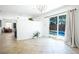 Bright living room with tiled flooring, sliding glass doors to pool area, and neutral decor at 10902 Pentland Downs St, Las Vegas, NV 89141