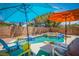 Outdoor pool area with inviting lounge chairs and umbrellas, perfect for summer relaxation at 10902 Pentland Downs St, Las Vegas, NV 89141