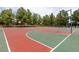 Outdoor basketball court with multiple hoops, surrounded by mature trees and greenery at 1413 Gentle Brook St, North Las Vegas, NV 89084