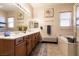 Luxurious bathroom featuring dual sinks, a soaking tub, a large mirror, and generous lighting at 1413 Gentle Brook St, North Las Vegas, NV 89084