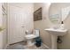 Cozy powder room with pedestal sink, tile floors, and neutral wall color at 1413 Gentle Brook St, North Las Vegas, NV 89084
