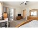 Large main bedroom featuring a ceiling fan, carpet flooring, and patio access at 1413 Gentle Brook St, North Las Vegas, NV 89084