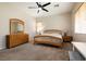 Bright bedroom with natural wood accents, neutral colors, and lots of sunlight at 1413 Gentle Brook St, North Las Vegas, NV 89084