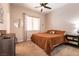 Bedroom with a ceiling fan, double windows, and neutral colored walls at 1413 Gentle Brook St, North Las Vegas, NV 89084