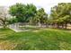Dog park with green grass and mature trees, fully fenced, providing a safe and fun area for pets at 1413 Gentle Brook St, North Las Vegas, NV 89084