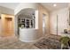 Inviting entryway with arched openings, neutral walls, and a patterned rug leading into the home at 1413 Gentle Brook St, North Las Vegas, NV 89084