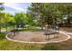 Outdoor exercise area featuring workout equipment, benches, and shade trees in a park setting at 1413 Gentle Brook St, North Las Vegas, NV 89084