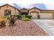 Inviting single-story home with a stone facade, well-kept landscaping, and a spacious three-car garage at 1413 Gentle Brook St, North Las Vegas, NV 89084