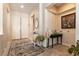 Elegant foyer featuring neutral walls, stylish console tables, tile flooring, and a decorative rug at 1413 Gentle Brook St, North Las Vegas, NV 89084