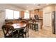 Charming eat-in kitchen featuring wooden cabinets, bar seating, a breakfast nook, and great natural lighting at 1413 Gentle Brook St, North Las Vegas, NV 89084