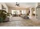 Bright living room with tile flooring, neutral walls, large windows and comfortable seating at 1413 Gentle Brook St, North Las Vegas, NV 89084