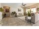 Spacious living room with neutral walls, comfortable sofas, indoor plants, and a ceiling fan at 1413 Gentle Brook St, North Las Vegas, NV 89084
