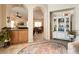 Inviting living area with arched doorways, a display cabinet, and a bright dining area, offering a seamless flow at 1413 Gentle Brook St, North Las Vegas, NV 89084