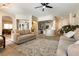 Open-concept living room with tile floors, a ceiling fan, and an arched entryway that adds architectural interest at 1413 Gentle Brook St, North Las Vegas, NV 89084