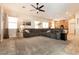 Open living room featuring a ceiling fan, ample seating, and natural light that creates a comfortable and welcoming space at 1413 Gentle Brook St, North Las Vegas, NV 89084