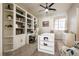 Well-lit home office with built-in bookshelves, a ceiling fan, a bright window, and a comfortable workspace at 1413 Gentle Brook St, North Las Vegas, NV 89084