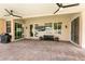 Spacious covered patio with ceiling fans and a mounted television at 1413 Gentle Brook St, North Las Vegas, NV 89084