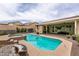 Backyard with a pool, hot tub, covered patio, and a well-manicured lawn at 1413 Gentle Brook St, North Las Vegas, NV 89084