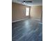 Bright, open bedroom features fresh neutral paint, laminate wood flooring, and a ceiling fan at 1511 Balsam Mist Ave, Las Vegas, NV 89183