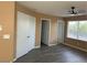 Bedroom featuring grey wood-look floors, closet doors and doorway to bathroom at 1511 Balsam Mist Ave, Las Vegas, NV 89183