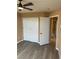 Bedroom showcases grey flooring, closet with sliding doors, and a ceiling fan at 1511 Balsam Mist Ave, Las Vegas, NV 89183