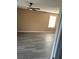 Bright bedroom with a ceiling fan, neutral paint, and durable laminate wood flooring at 1511 Balsam Mist Ave, Las Vegas, NV 89183