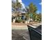 View of the two-story home with tile roof seen from street, highlighting well-maintained landscaping and corner lot at 1511 Balsam Mist Ave, Las Vegas, NV 89183