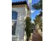 Charming home exterior with stucco walls, arched window, and landscaped grounds at 1511 Balsam Mist Ave, Las Vegas, NV 89183