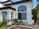 Close-up of the front yard showcasing the home's architectural details, arched windows, and landscaped garden beds at 1511 Balsam Mist Ave, Las Vegas, NV 89183