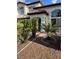 Welcoming front yard with mature trees, desert landscaping, and a covered entry at 1511 Balsam Mist Ave, Las Vegas, NV 89183