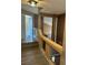 Bright hallway featuring hardwood floors, railing with glass and an open doorway at 1511 Balsam Mist Ave, Las Vegas, NV 89183