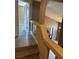 Hallway with hardwood flooring and an opening to a naturally lit living area at 1511 Balsam Mist Ave, Las Vegas, NV 89183