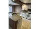 Bright kitchen featuring granite countertops, white cabinets, a stainless steel faucet, and tile flooring at 1511 Balsam Mist Ave, Las Vegas, NV 89183