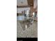 Kitchen featuring granite island with sink, tiled floors, white cabinets, and stainless steel appliances at 1511 Balsam Mist Ave, Las Vegas, NV 89183