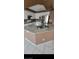 Kitchen featuring granite island with sink, tiled floors, white cabinets, and stainless steel appliances at 1511 Balsam Mist Ave, Las Vegas, NV 89183