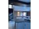 Open concept kitchen with stainless steel sink and granite countertops overlooking the living room at 1511 Balsam Mist Ave, Las Vegas, NV 89183