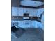 Updated kitchen with stainless steel appliances, granite countertops, and white cabinets at 1511 Balsam Mist Ave, Las Vegas, NV 89183