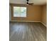 Spacious living room with hardwood floors, natural lighting, and a ceiling fan at 1511 Balsam Mist Ave, Las Vegas, NV 89183