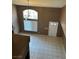 High-ceiling living room with large window and neutral tile flooring at 1511 Balsam Mist Ave, Las Vegas, NV 89183