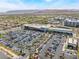 Aerial view of a shopping center with ample parking, retail spaces, and mountain views at 2152 Jasper Bluff St # 103, Las Vegas, NV 89117