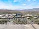 Overhead shot displays the retail shops, parking areas, road, palm trees, and mountain landscape at 2152 Jasper Bluff St # 103, Las Vegas, NV 89117
