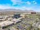 Aerial view featuring the outdoor mall, shopping area, roads, parking, palm trees, and mountainous terrain at 2152 Jasper Bluff St # 103, Las Vegas, NV 89117